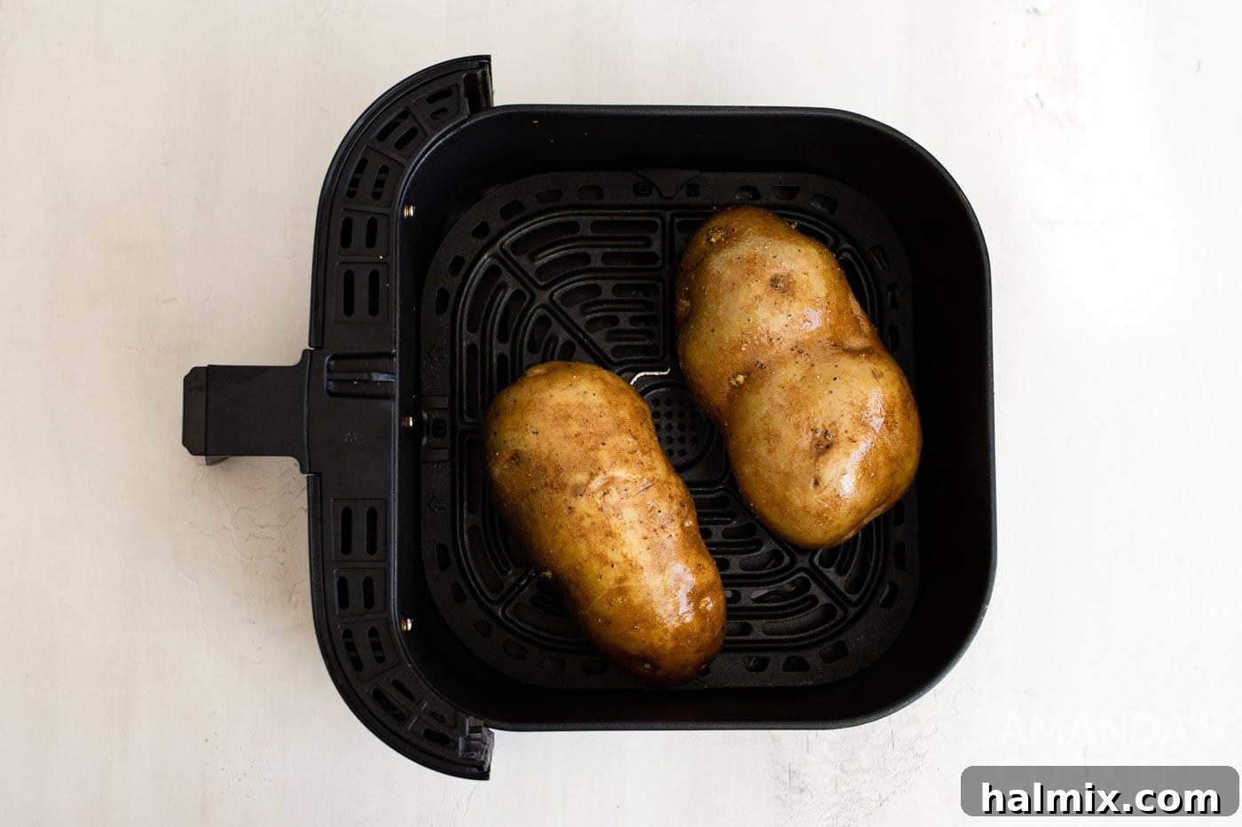 russet potatoes in an air fryer basket