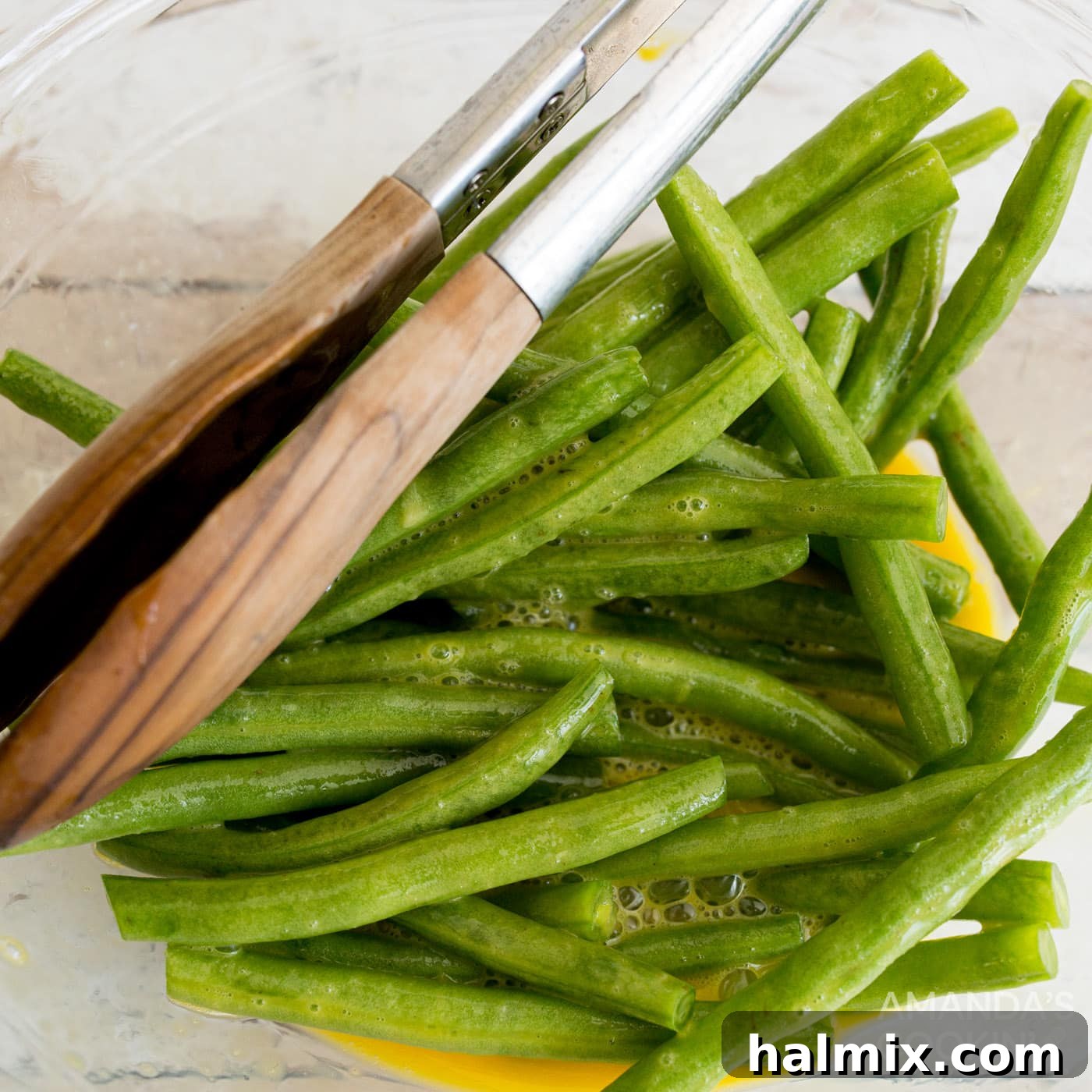 Air Fryer Green Bean Snaps 5 tossing green beans in a bowl of eggs