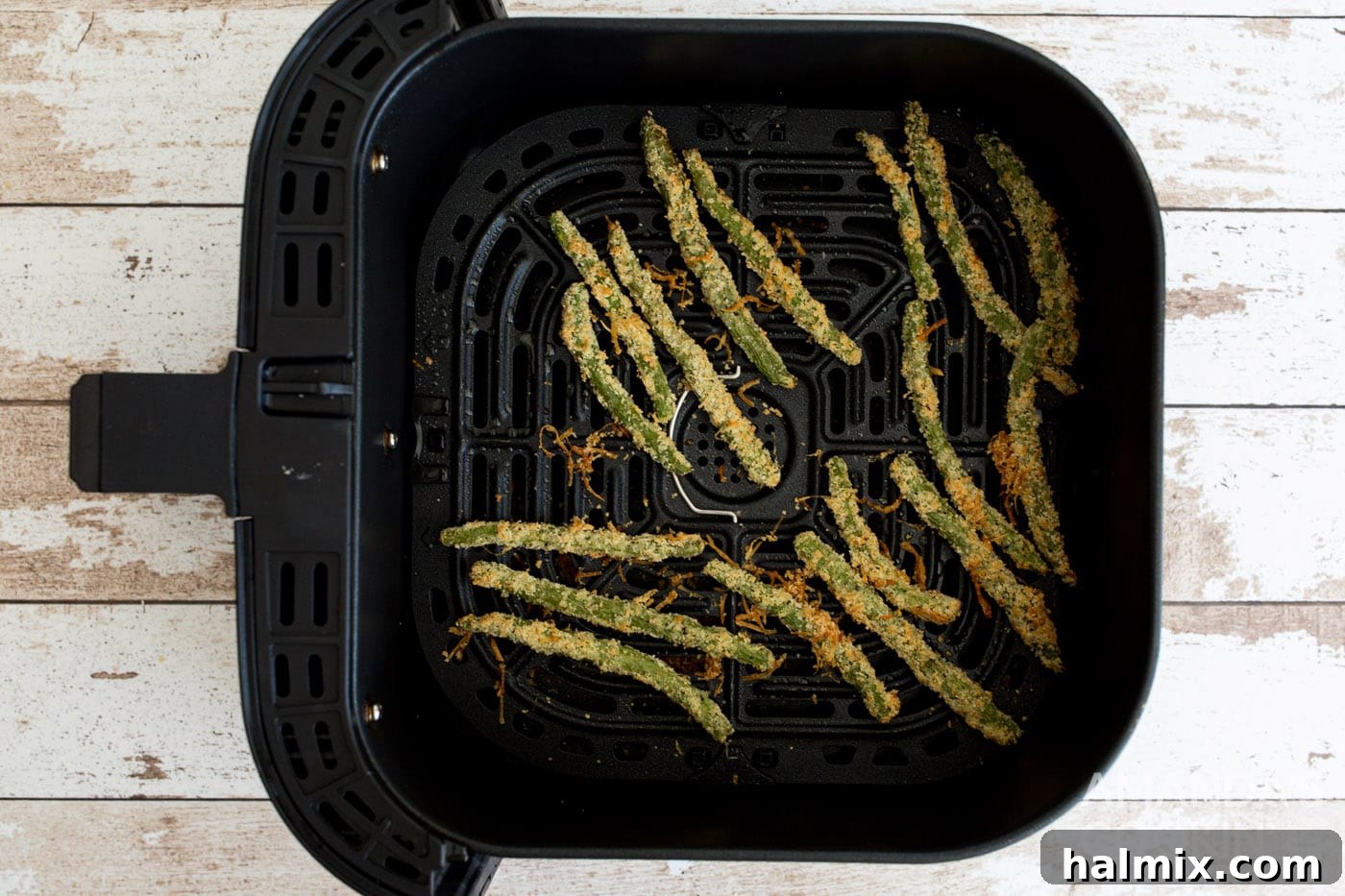 Air Fryer Green Bean Snaps 8 cooked green bean fries in air fryer basket