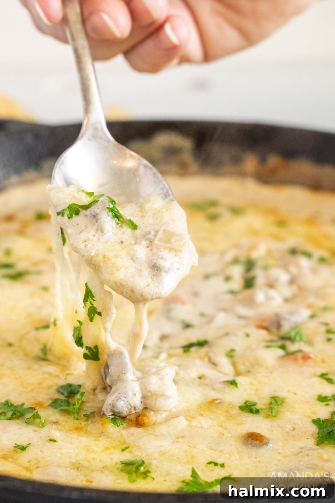 lifting Philly Cheesesteak Dip with a spoon