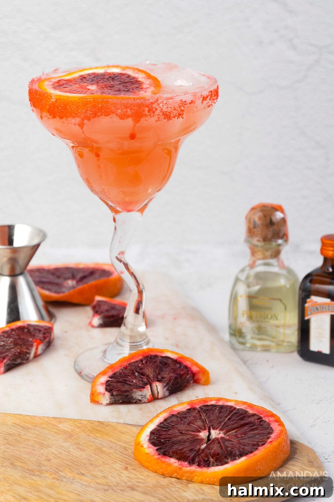 Crimson Sunset Margarita 3 Close-up shot of a blood orange margarita, showcasing its vibrant color and sugared rim.