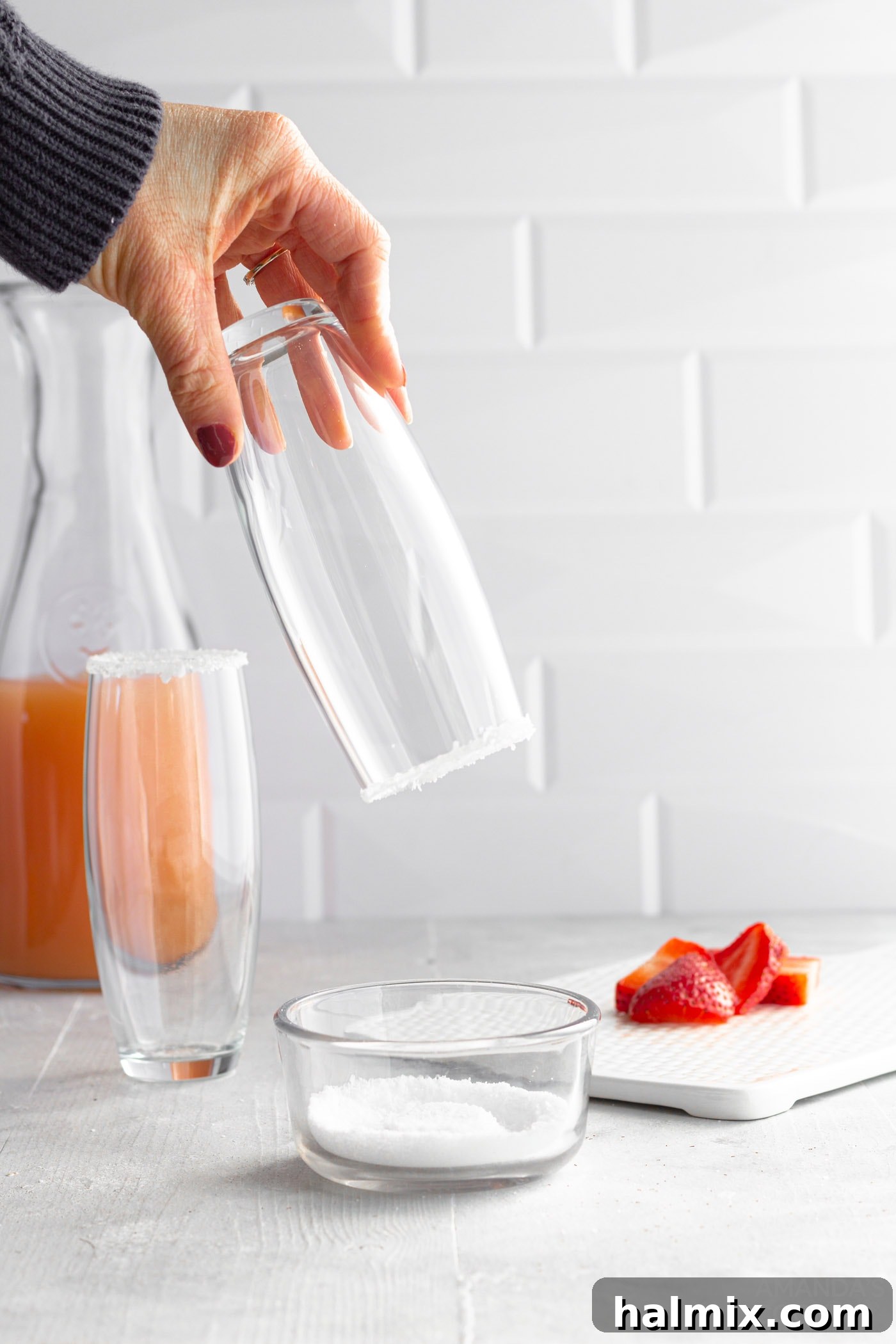 Dipping rim of glass in margarita salt