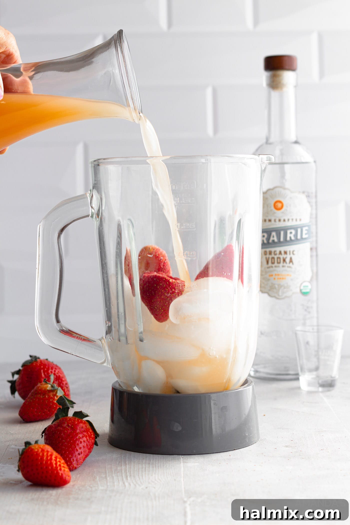 Strawberries, ice, grapefruit juice, and vodka in a blender