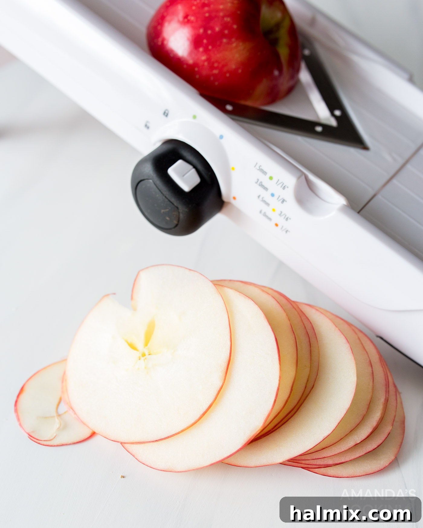 sliced apples next to a mandolin