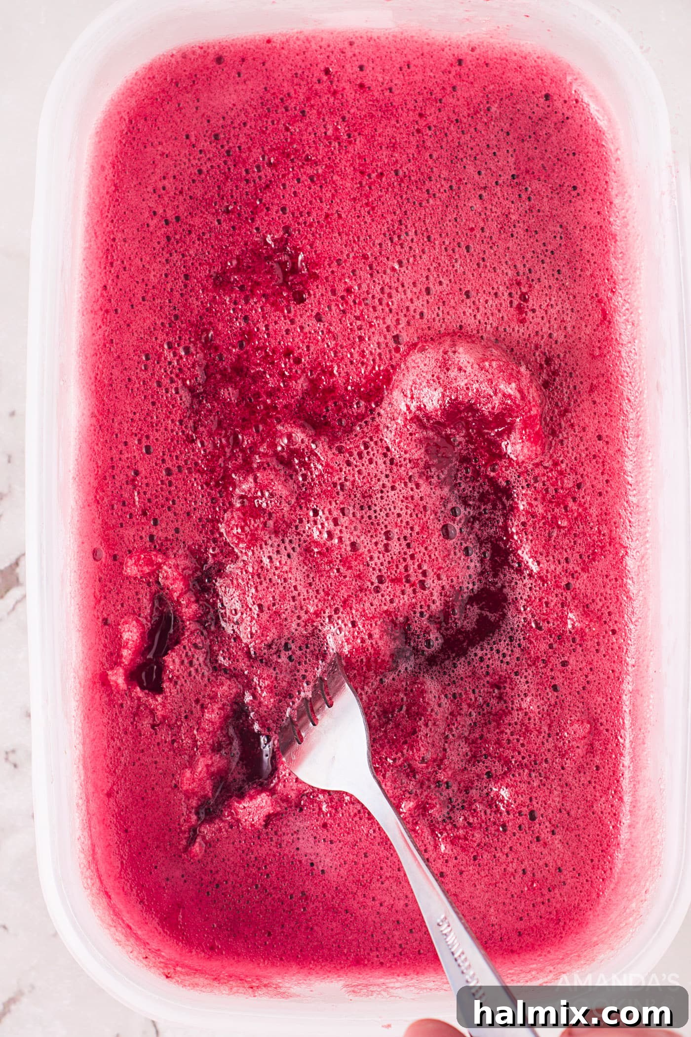 scrape cherry ice with a fork