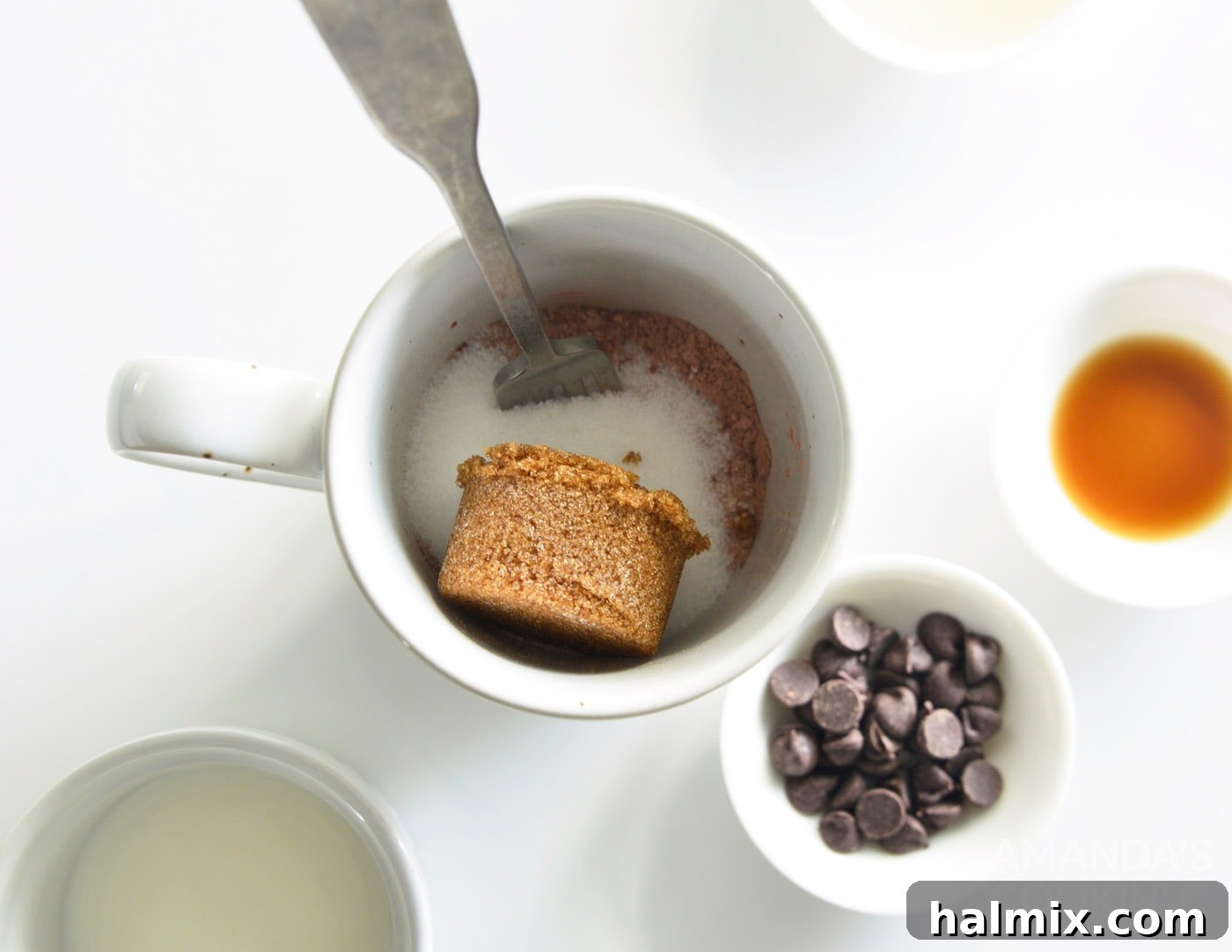 Brown sugar being added to mug cake dry ingredients.