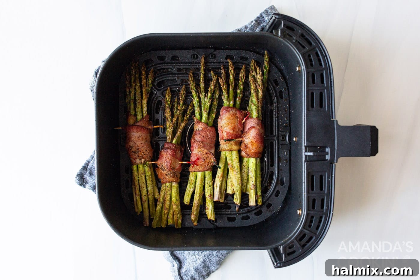 Cooked air fryer bacon wrapped asparagus, golden and crispy, fresh out of the air fryer