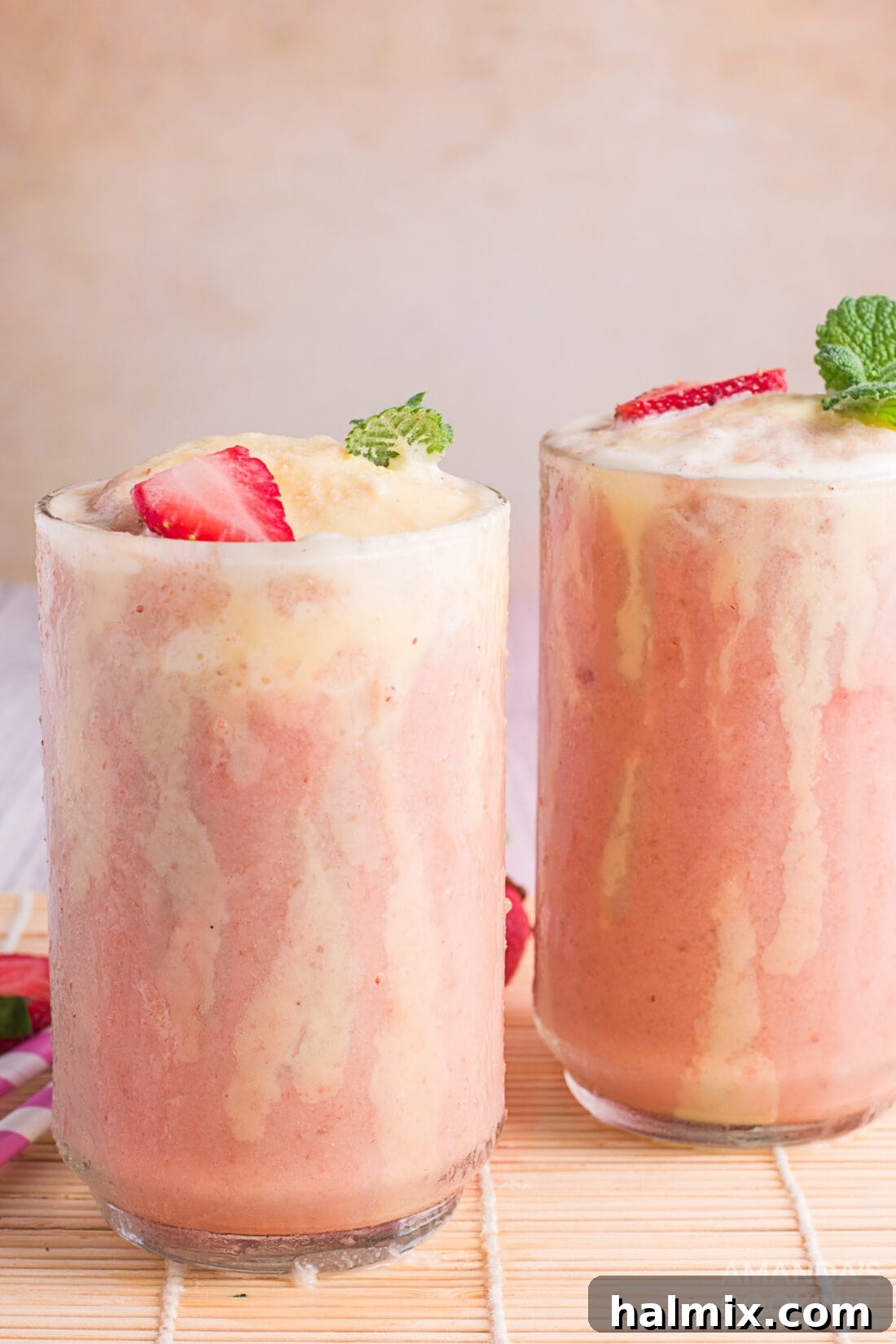 Berry Banana Bubble Bliss 3 Two Strawberry Banana Fizzy Floats in tall glasses, with a focus on the frothy tops and ice cream.