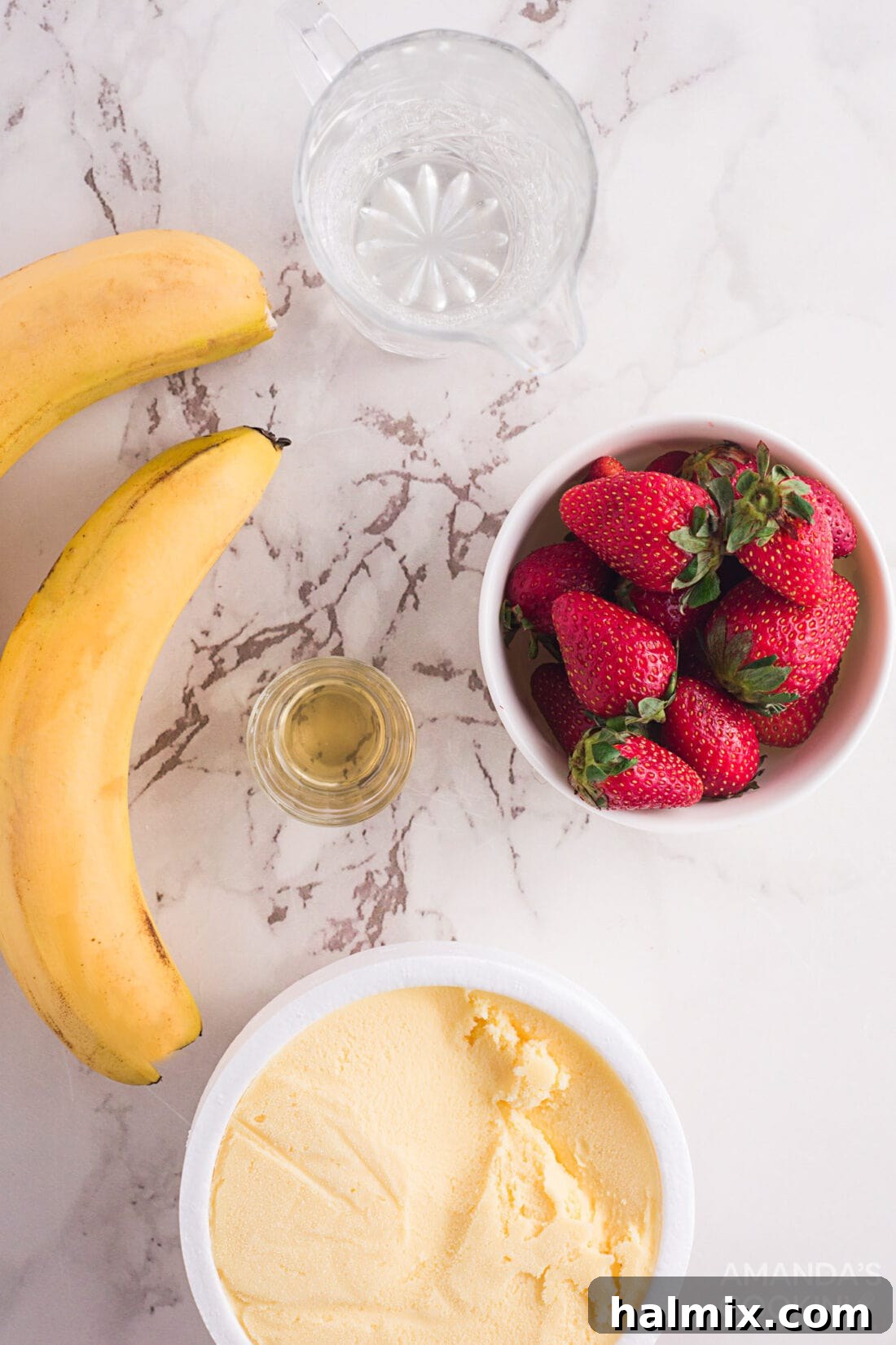 Berry Banana Bubble Bliss 4 A flat lay of ingredients for strawberry banana floats including fresh strawberries, bananas, a bottle of club soda, and simple syrup.