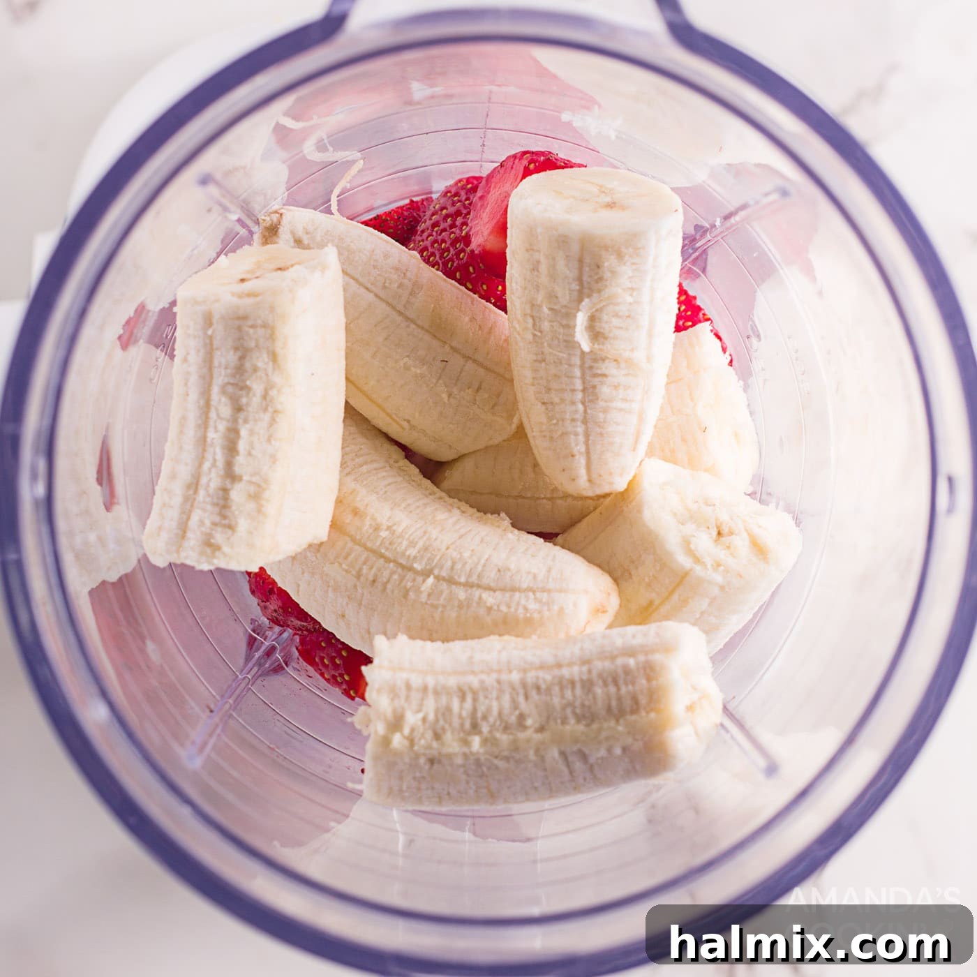 bananas in a blender with strawberries