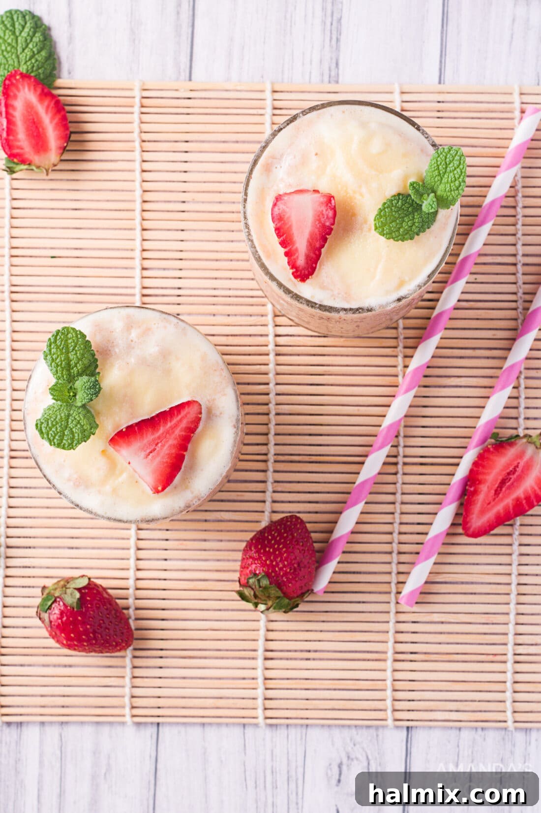 Berry Banana Bubble Bliss 10 overhead photo of Strawberry Banana Fizzy Float with a spoon, showing the layers of fruit, soda, and ice cream.