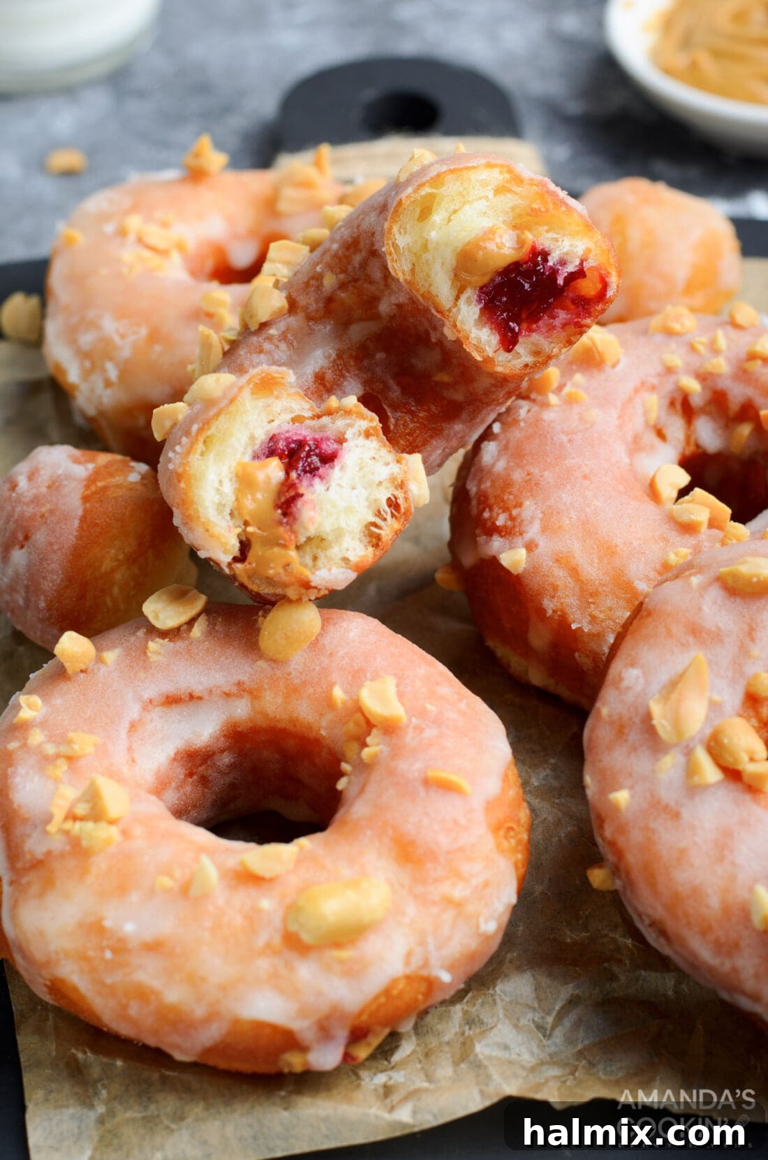 Peanut Butter & Jelly Donuts in half showing the inside, revealing the luscious filling.