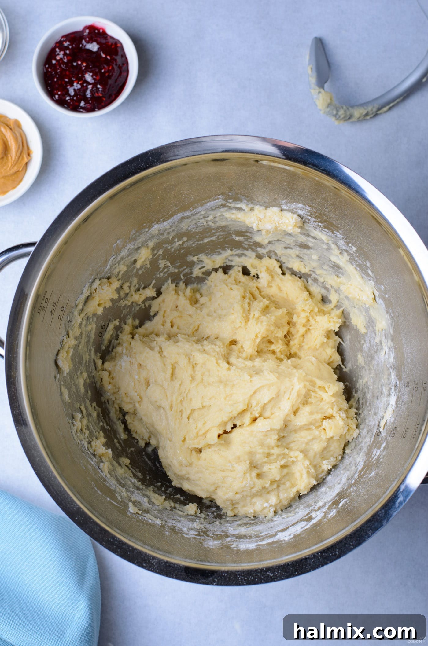 Smooth, well-kneaded donut dough resting inside a mixing bowl, ready for proofing.