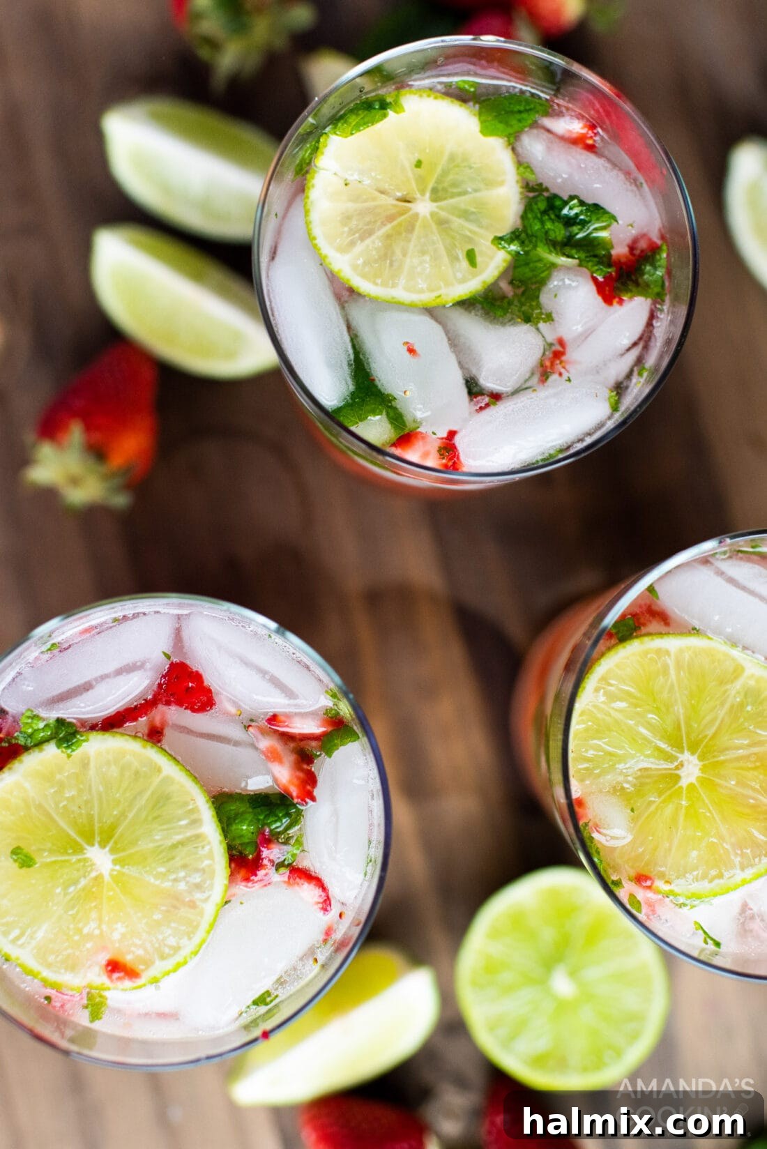 Overhead shot of two Strawberry Mojitos, showcasing their vibrant color and fresh garnishes