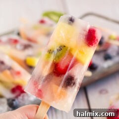 Homemade Fruit Popsicles with various fruits and juice