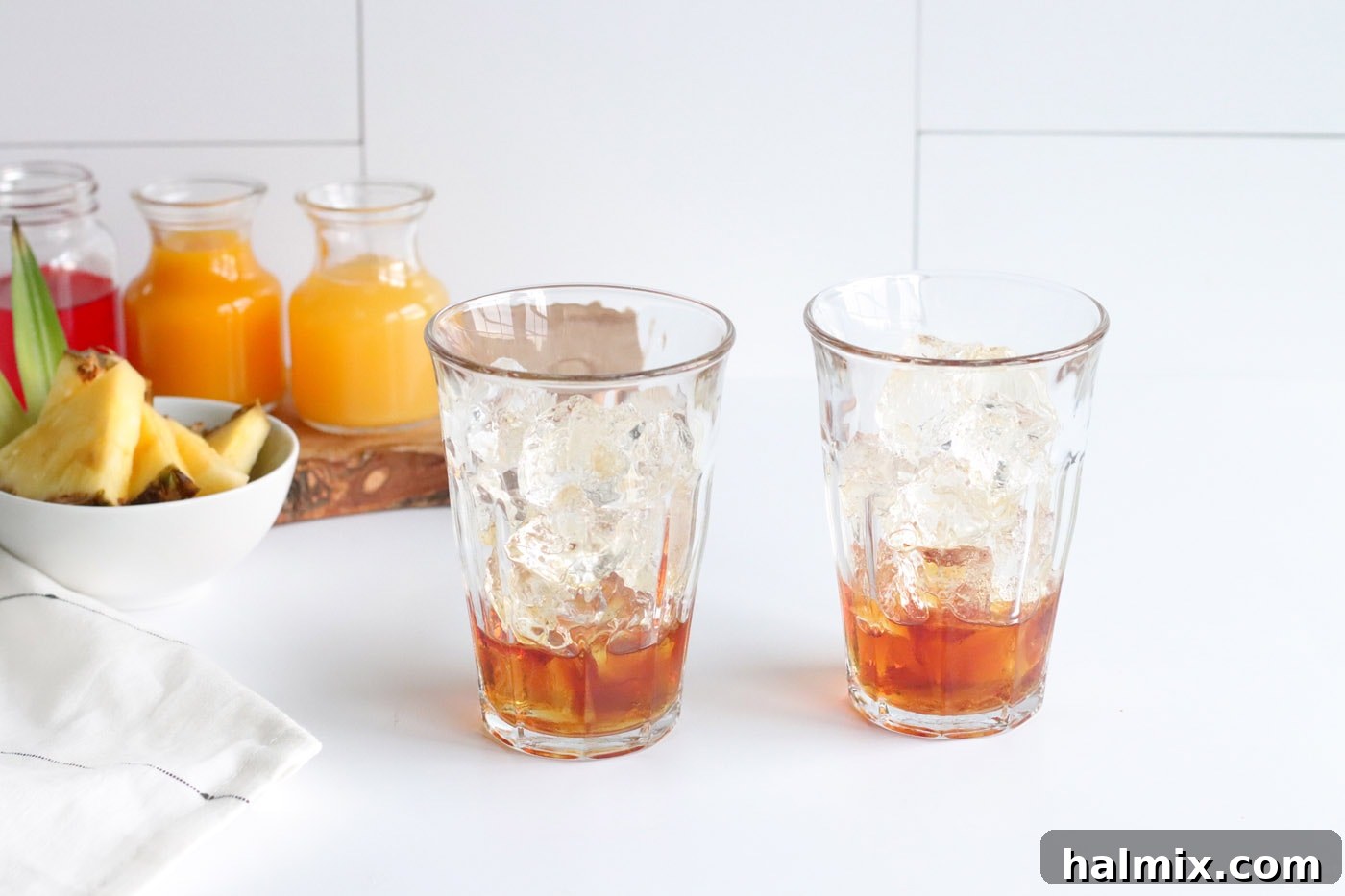 dark rum in a glass of ice, poured over ice cubes, creating the first layer of the cocktail.