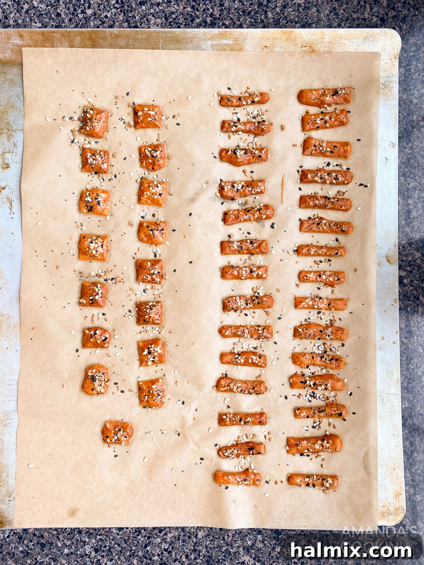 Freshly baked and golden-brown cheese squares cooling on a baking sheet.