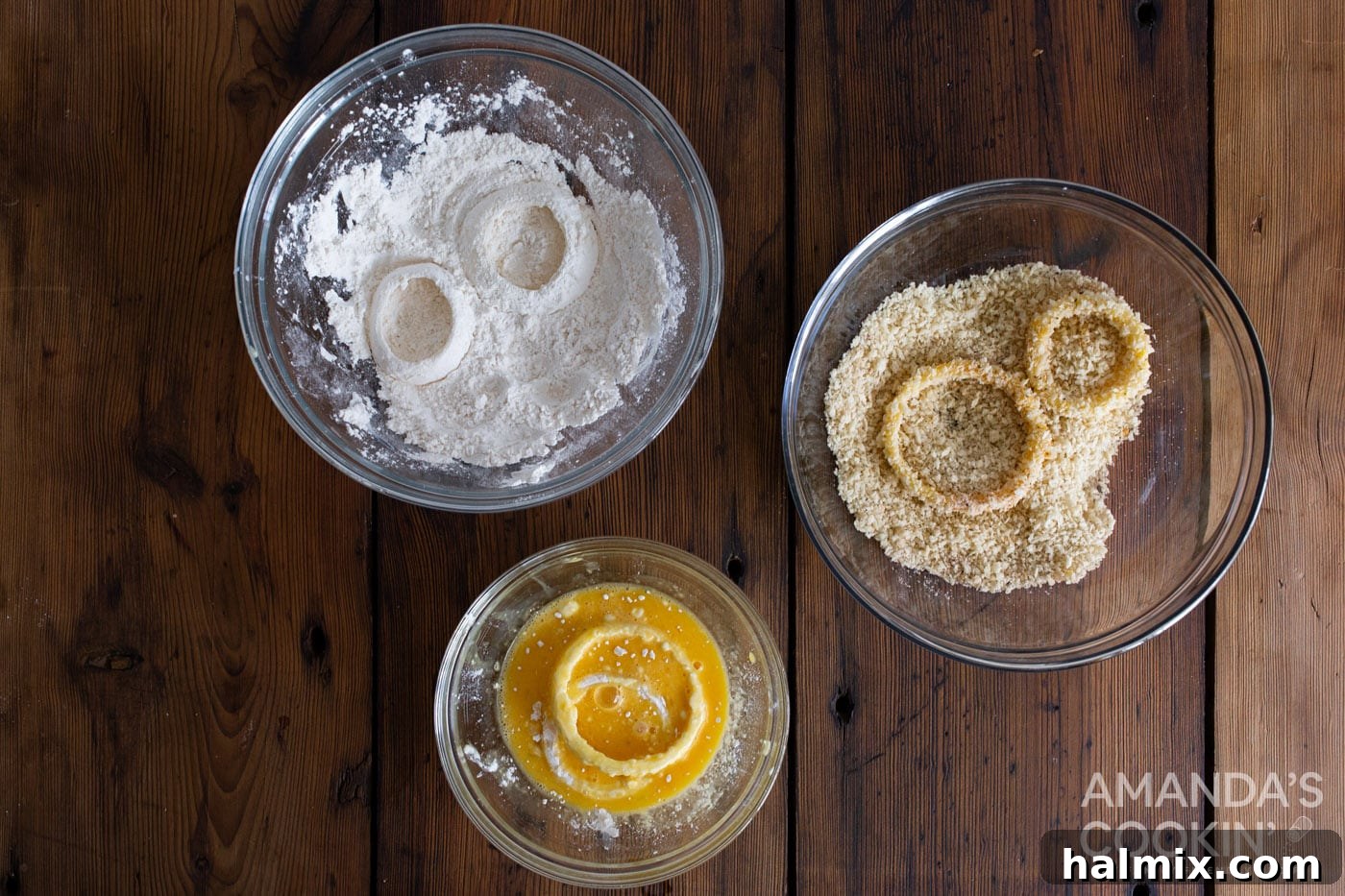 Golden Air-Fried Onion Rings 6 A sequence of photos showing onion rings being dipped in bowls of flour, whisked eggs, and seasoned panko breadcrumbs.