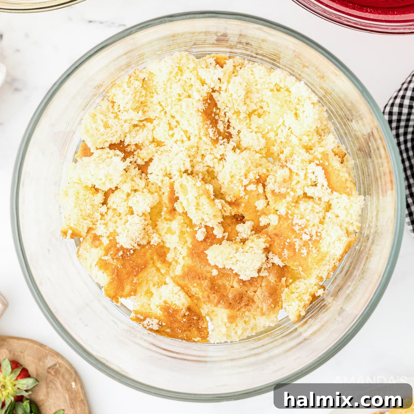 Crumbled cake forming the first layer in a trifle dish