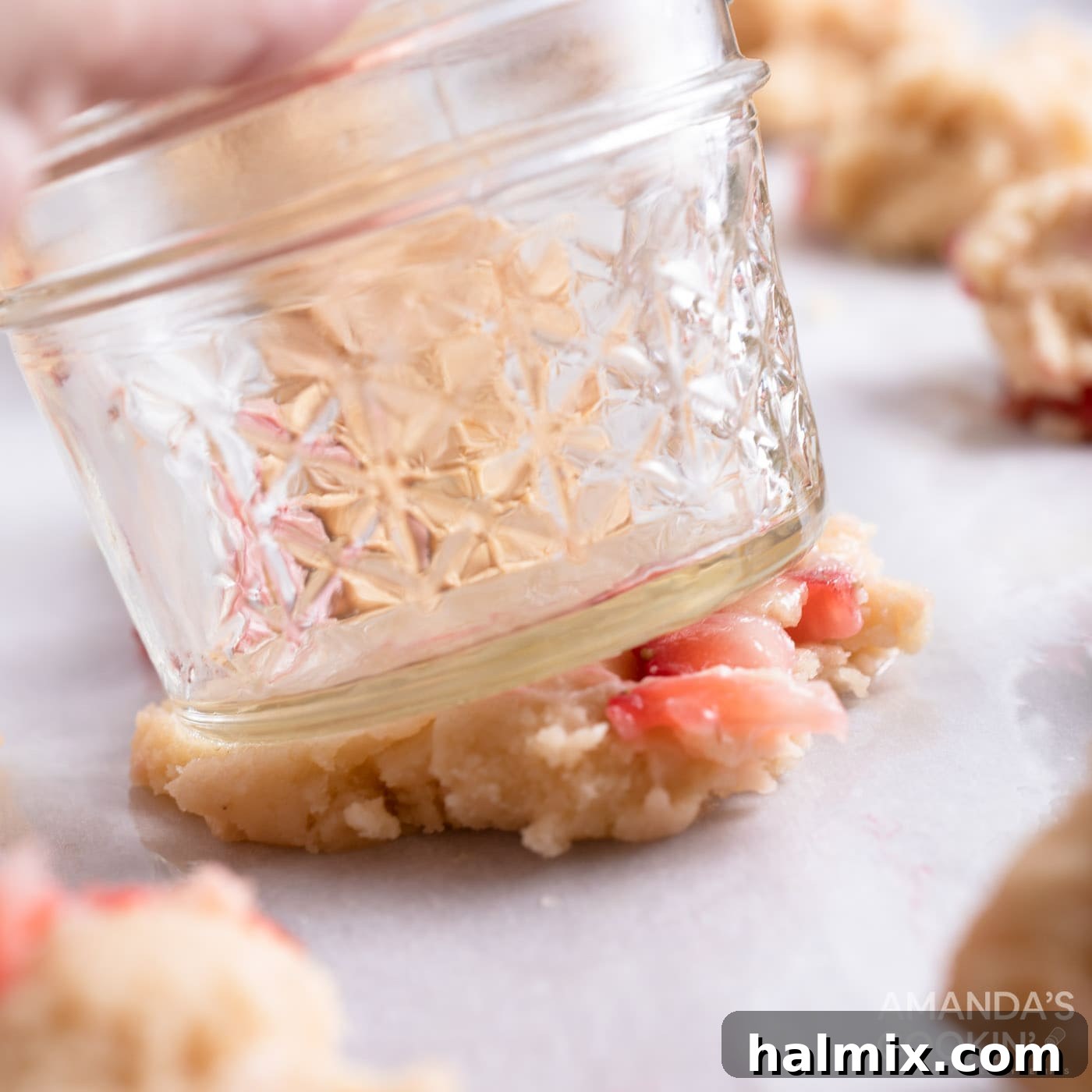 using a mason jar to flatten cookie dough balls
