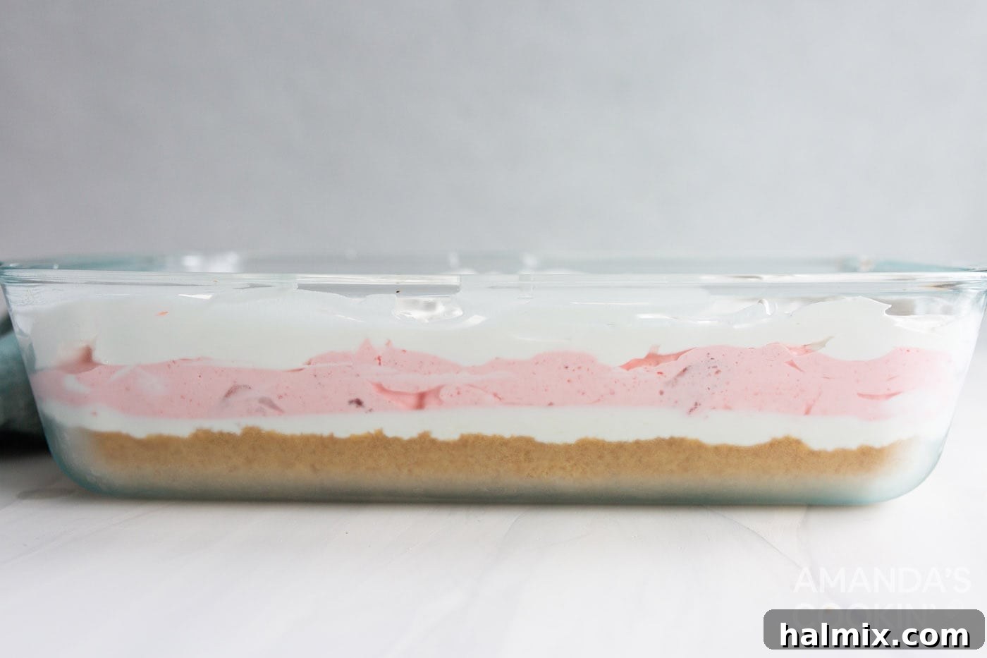 The final layer of Cool Whip spread evenly over the layered strawberry lasagna dessert