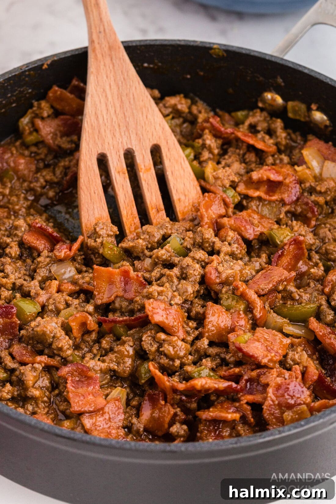 Bacon Sloppy Joes simmering in a skillet on the stovetop