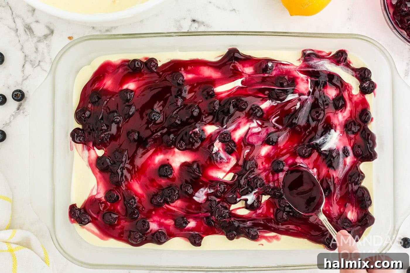 Zesty Lemon Blueberry No-Bake Delight 8 spreading blueberry pie filling on top of pudding
