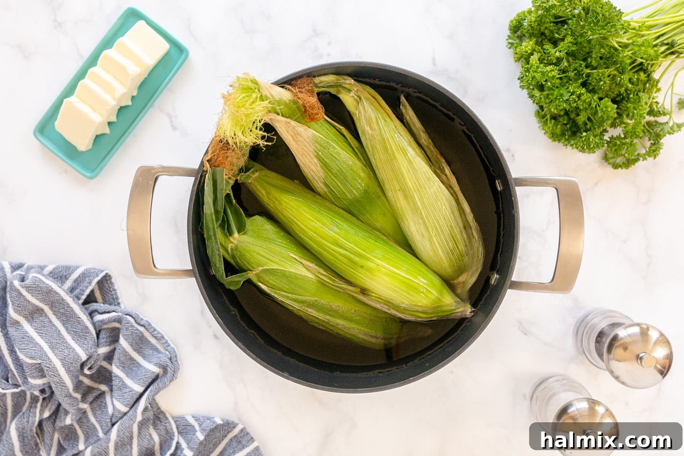 corn on the cob in a pot of water for soaking
