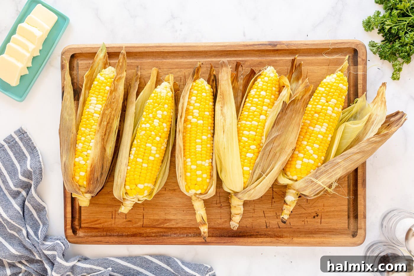 peeled grilled corn on the cob on a cutting board, ready to be served