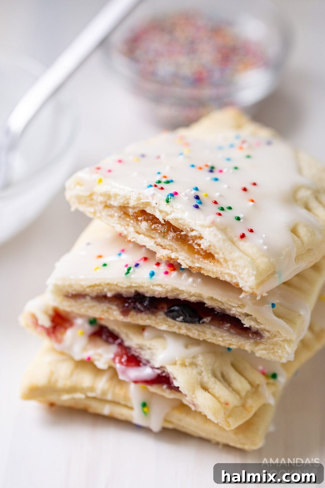 Stack of homemade pop tarts cut in half, revealing the jam filling