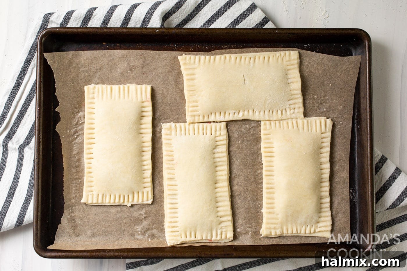Assembled pastries on a baking sheet, ready for the oven