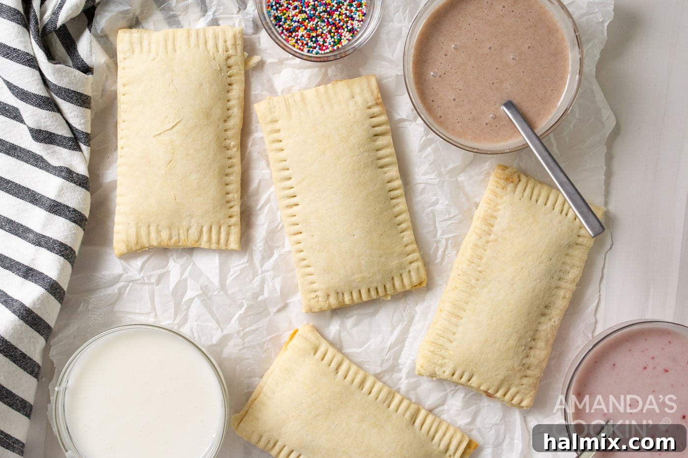 Freshly baked pop tarts with a bowl of glaze on the side