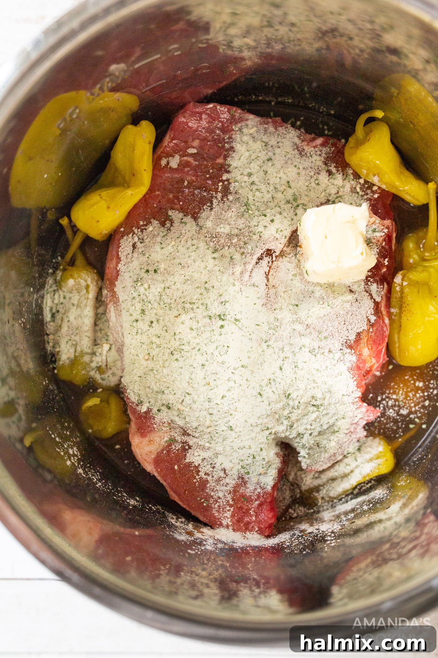 Mississippi Magic in Your Instant Pot 5 chuck roast with seasonings and pepperoncinis in instant pot