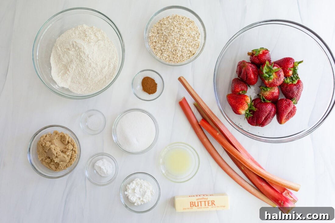 A collection of fresh ingredients for crumble bars laid out on a wooden surface, including ripe strawberries, vibrant rhubarb stalks, flour, oats, butter, and sugars