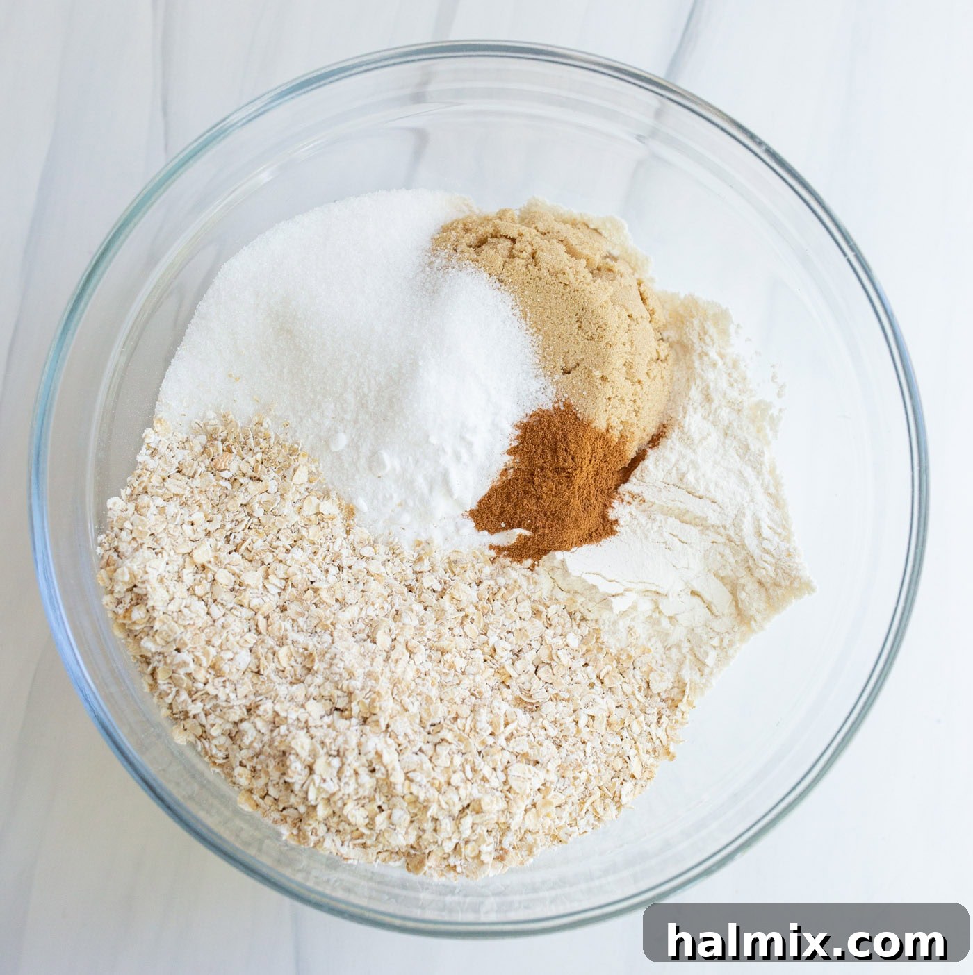 Close-up of crumble topping ingredients being mixed in a bowl, showcasing the buttery, coarse texture ideal for the crust