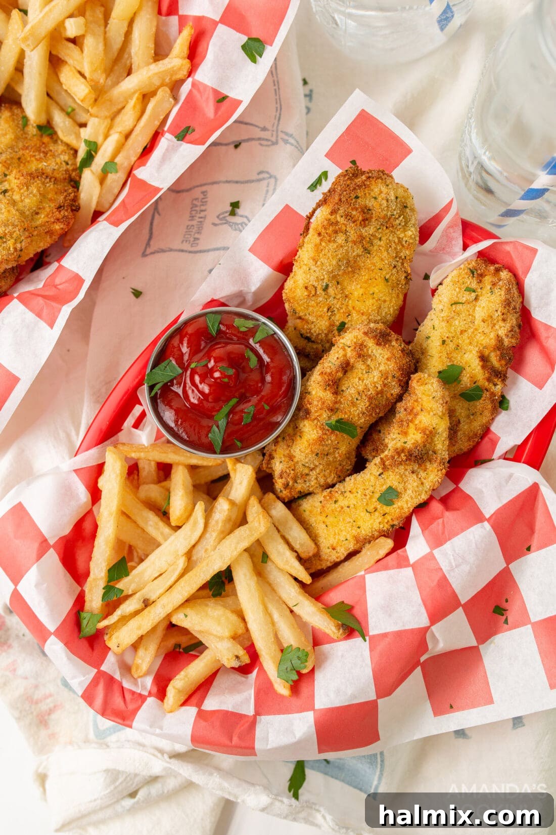 Crispy air fryer chicken tenders served in baskets with golden french fries