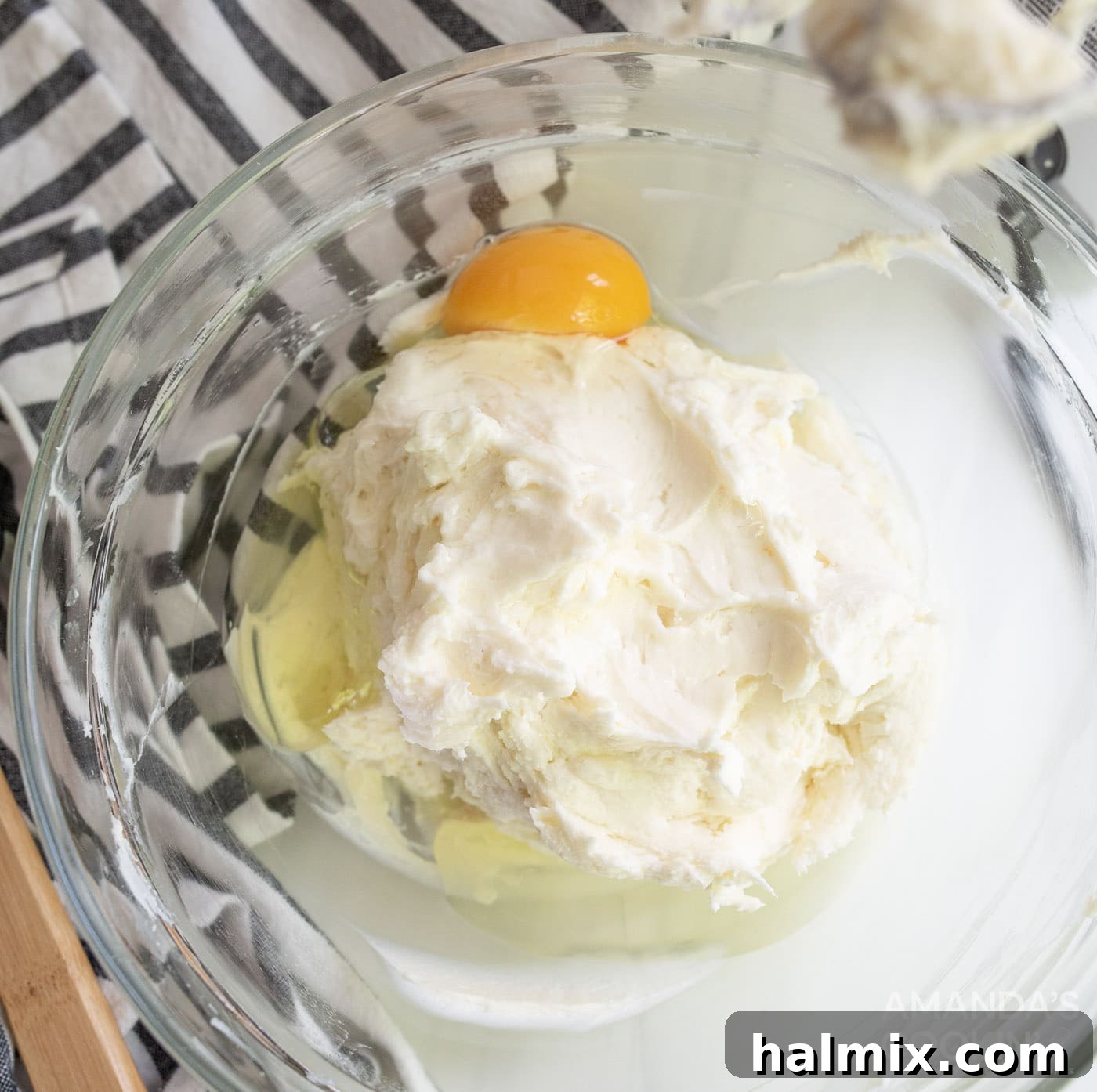 lemon juice, vanilla extract, and an egg in bowl with cream cheese mixture