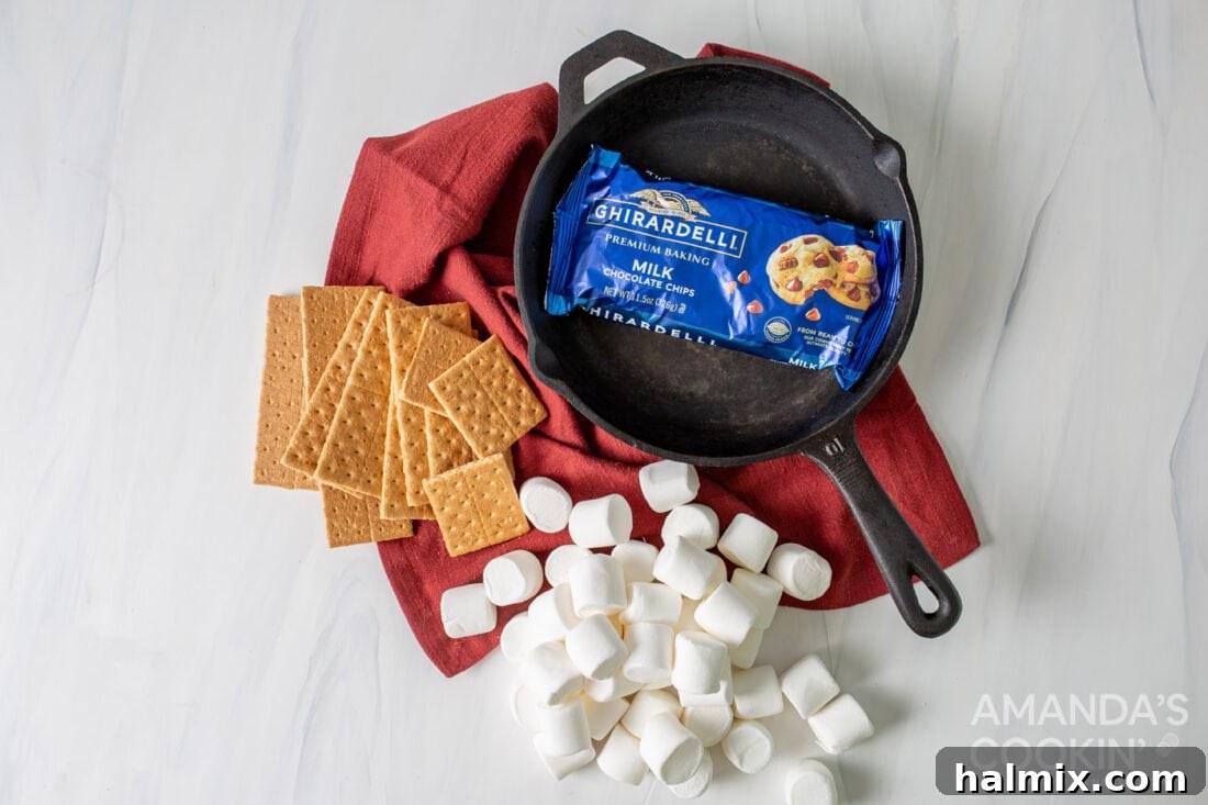 Gooey S'mores Skillet 4 Close-up of ingredients for making s'mores dip: chocolate chips, marshmallows, and graham crackers