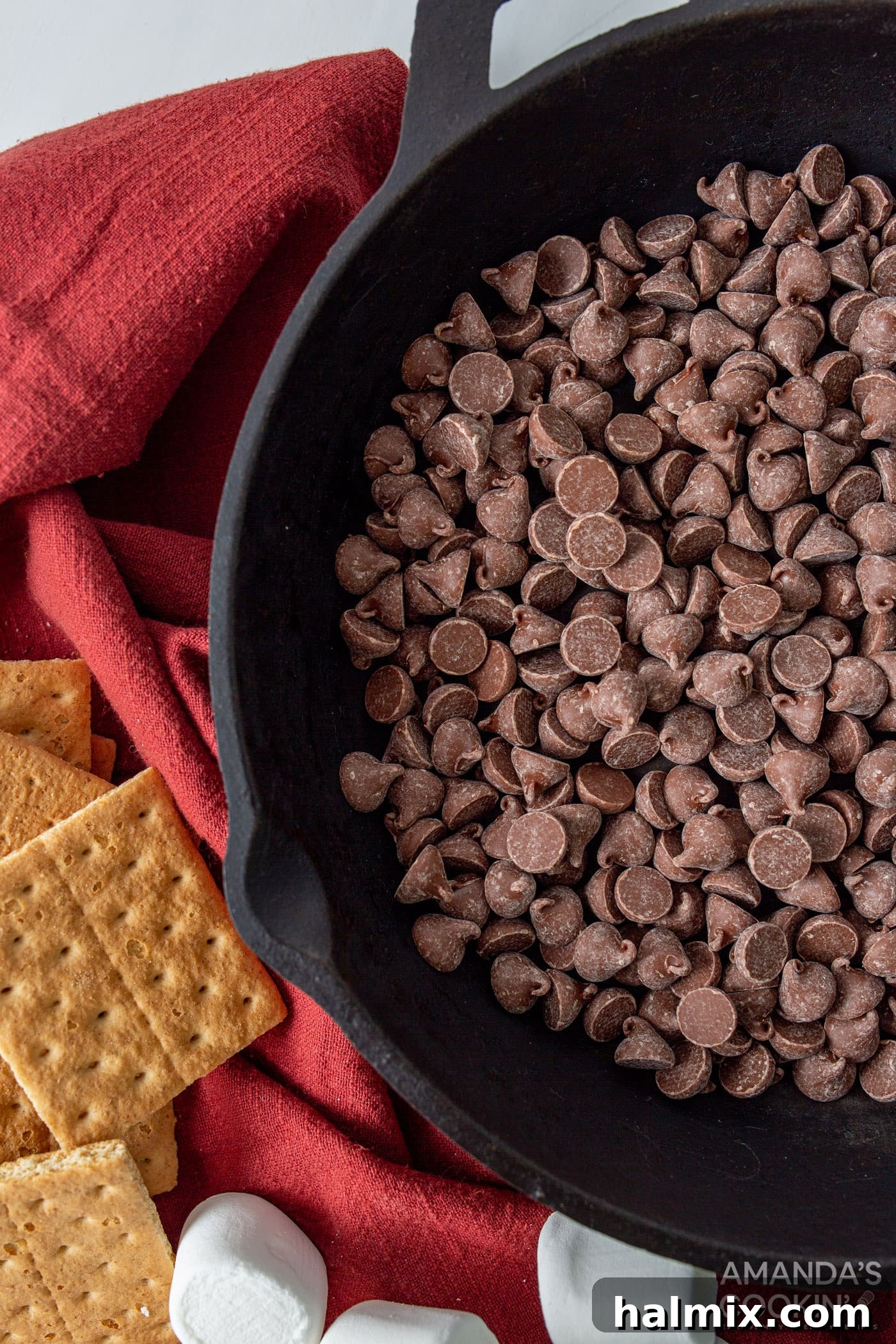 Gooey S'mores Skillet 5 chocolate chips spread evenly in an 8-inch cast iron skillet