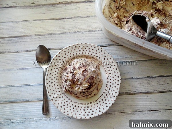 nutella-swirl-cheesecake-ice-cream-5 An overhead photo Nutella swirl cheesecake ice cream on a plate served with a spoon.