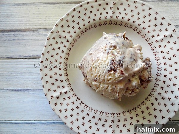 nutella-swirl-cheesecake-ice-cream-3 A close up overhead photo of a scoop of Nutella swirl cheesecake ice cream on a plate.