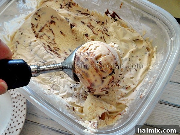 nutella-swirl-cheesecake-ice-cream-1 A close up photo of an ice cream scoop scooping out Nutella swirl cheesecake ice cream.