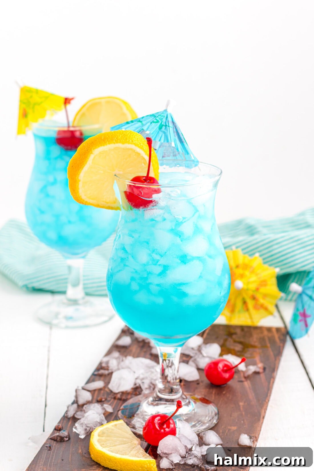 Azure Escape 8 Two Blue Lagoon Cocktails, perfectly garnished and ready to serve.