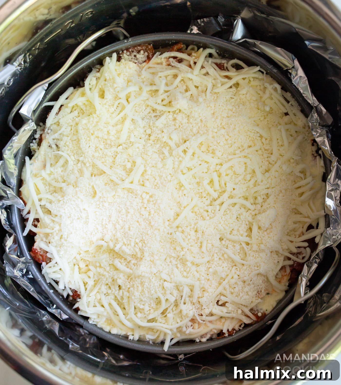 Effortless Instant Pot Lasagna 12 The springform pan, with lasagna assembled and bottom wrapped in aluminum foil, is gently placed onto the trivet inside the Instant Pot, ready for pressure cooking.