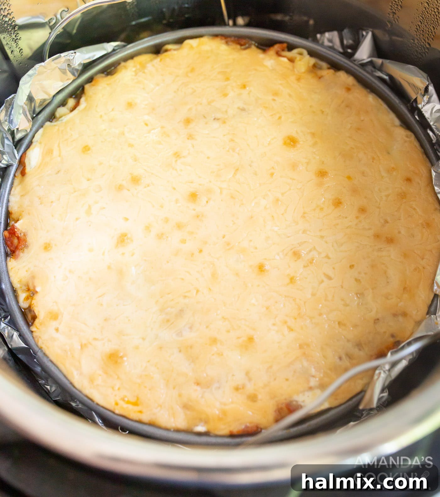 Effortless Instant Pot Lasagna 13 The perfectly baked Instant Pot Lasagna, with a golden-brown top, removed from the pressure cooker and ready to rest before slicing.