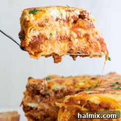 Spatula lifting a slice of perfectly cooked Instant Pot Lasagna, showing the delicious layers.