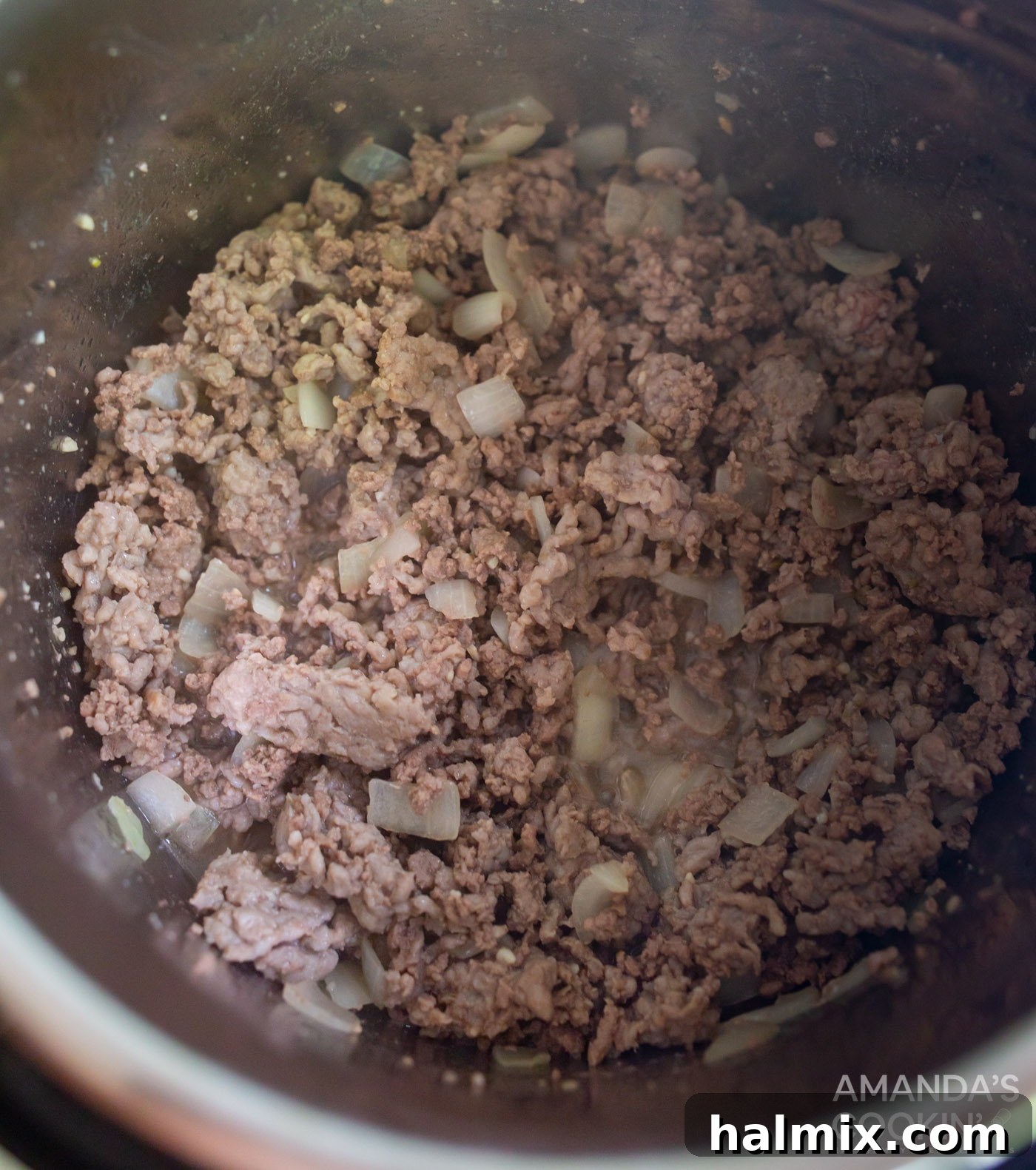 Effortless Instant Pot Lasagna 5 Ground pork, beef, and chopped onions sautéing in an Instant Pot until nicely browned.