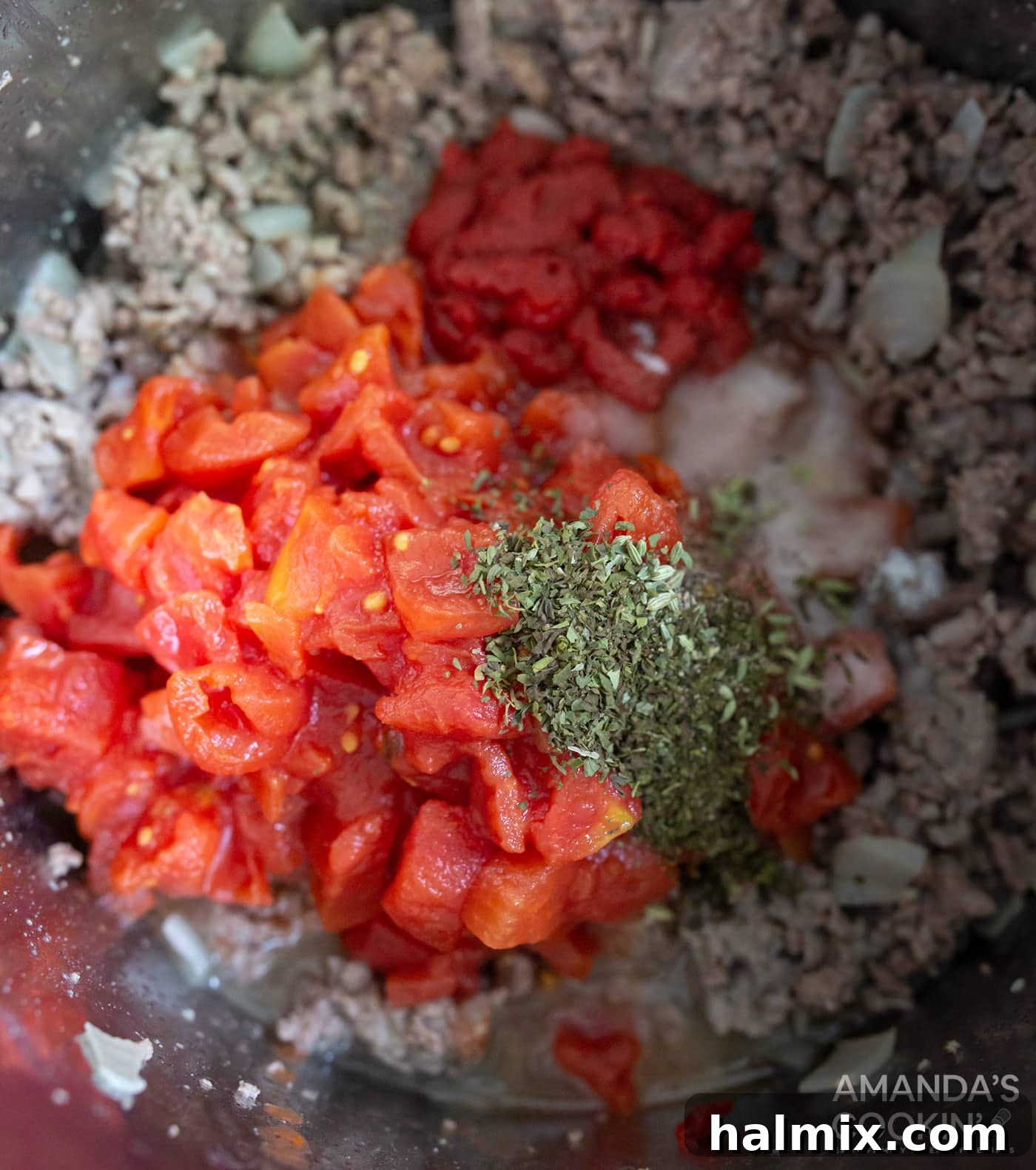 Effortless Instant Pot Lasagna 6 The meat sauce ingredients, including tomatoes, herbs, and spices, are stirred into the sautéed meat in the Instant Pot, ready for pressure cooking.