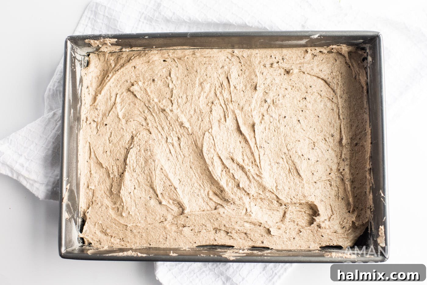 Oreo cake batter spread in a baking pan, ready for the oven