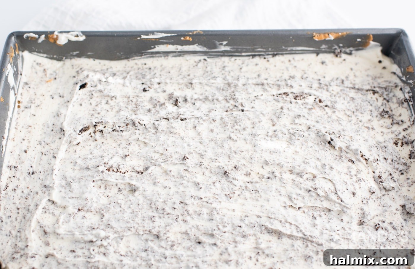 Close-up of the partially set Oreo cheesecake mixture in a pan